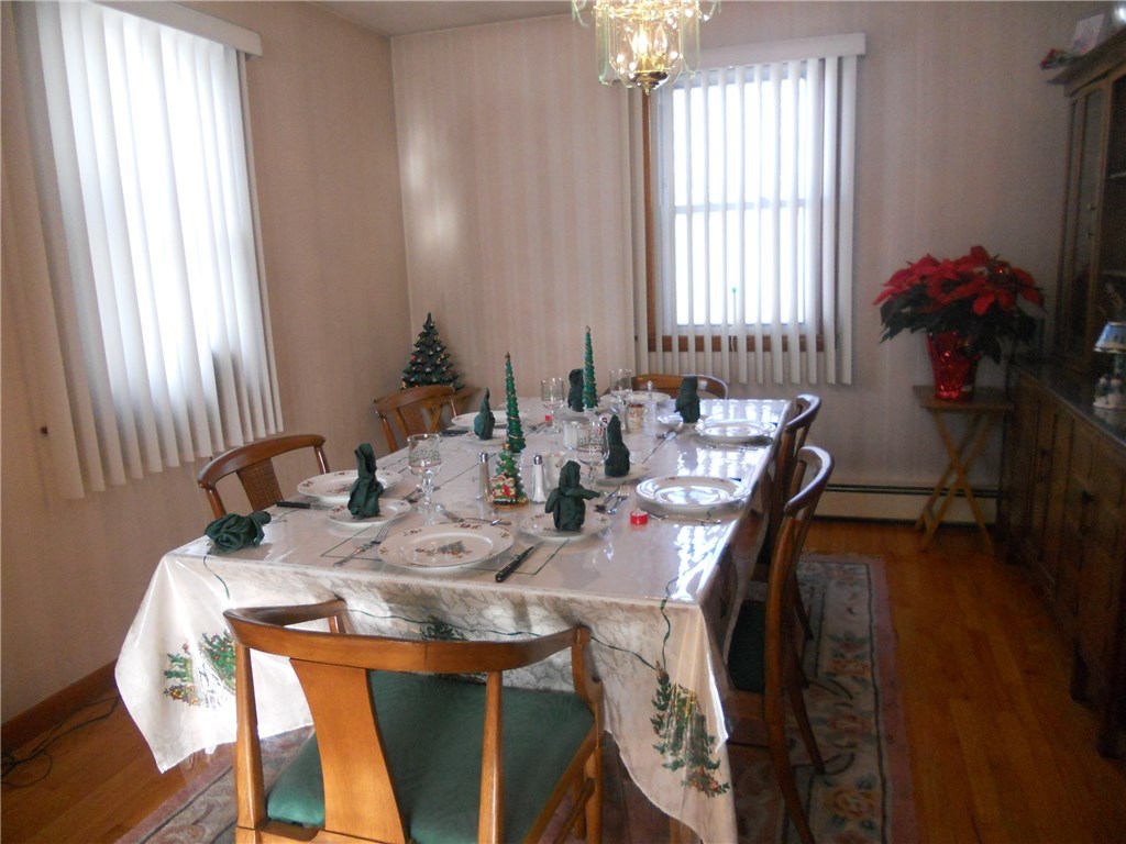 12 Lawrence Road North Providence, RI 02911 - Photo 28 of 40 FORMAL DINING ROOM, CONVENIENTLTY LOCATED RIGHT OFF KITCHEN, TABLE FITS 8 COMFORTABLY FOR DINNER AND ENTERTAINMENT, OF COURSE ALL HARDWOOD FLOORING. ROOM SIZE 12 FT 6 IN X 11 FT 6 IN
