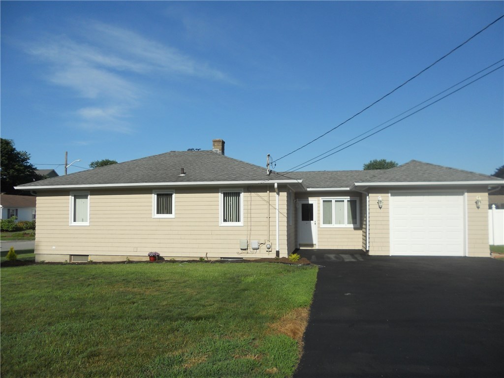 SIDE VIEW ON CORNER LOT, with CASEMENT WINDOWS SHOWING WITH DOUBLE WIDE DRIVEWAY-FRESHLY SEAL COATED, ALONG WITH 24 X 14 {336 SQUARE FOOT} OVER SIZED 1 CAR GARAGE WITH NEWER GARAGE DOOR AND 2 DOOR OPENERS. GARAGE ENTERS BREEZEWAY, WHICH ENTERS THE KITCHEN, GREAT FOR THOSE COLD WINDY DAYS OR RAINY DAYS-STAY WARMER AND DRYER, AND KEEP YOUR CAR NEWER JUST DRIVE IN YOUR LARGE GARAGE.