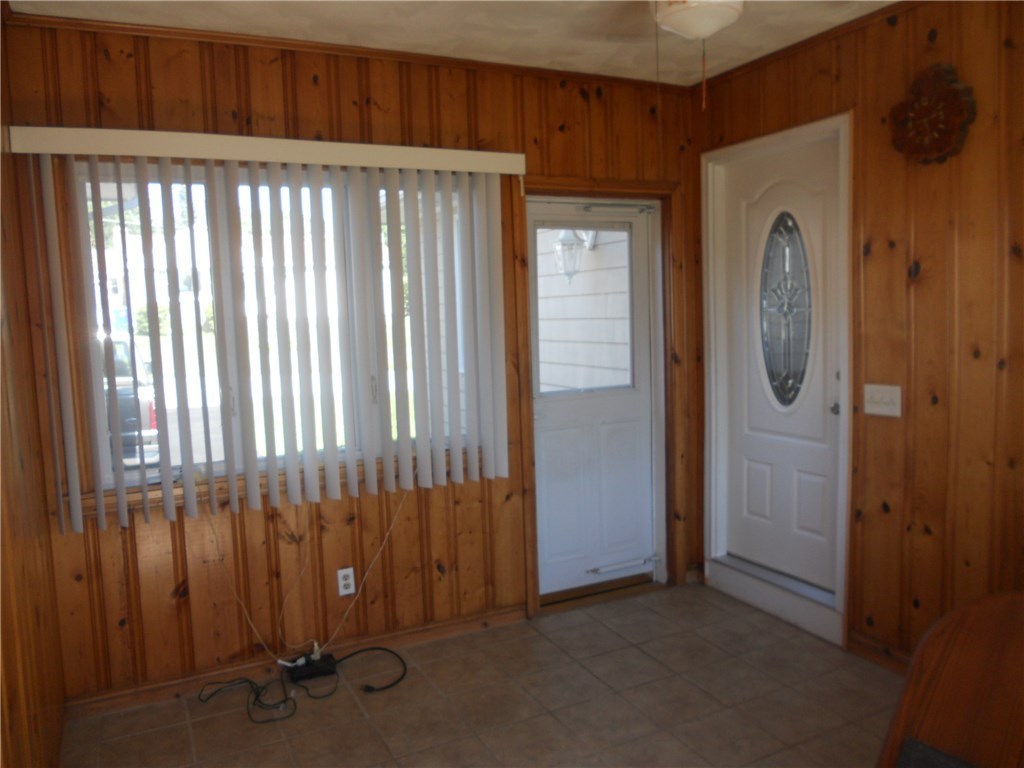 12 Lawrence Road North Providence, RI 02911 - Photo 35 of 40 13 X 10 3 SEASON ROOM w/AC, HAS 4 ENTRANCES TO: LARGE SINGLE CAR GARAGE, KITCHEN, WITH REAR EXIT TO FENCED BACKYARD AND TO DRIVEWAY. NEWER GARAGE DOOR AND KITCHEN DOOR