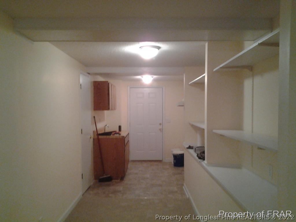 5074 Summer Ridge Road Fayetteville, NC 28303 - Photo 13 of 14 a hallway with a couch