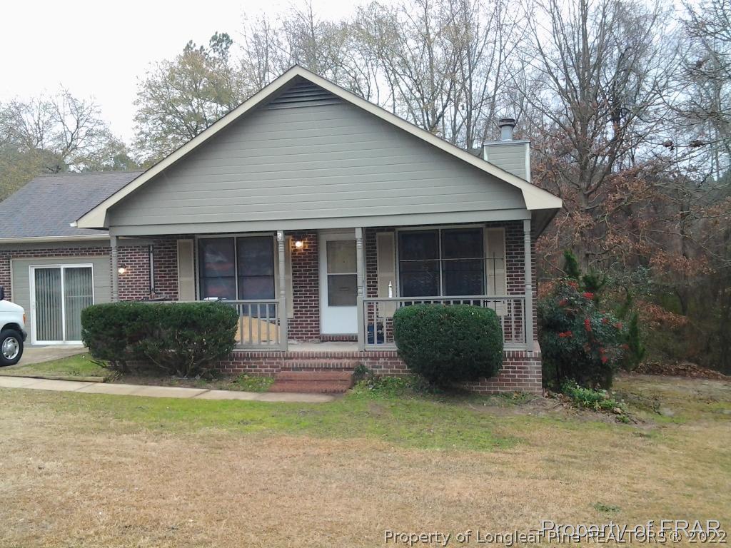 5074 Summer Ridge Road Fayetteville, NC 28303 - Photo 14 of 14 a front view of a house with a garden