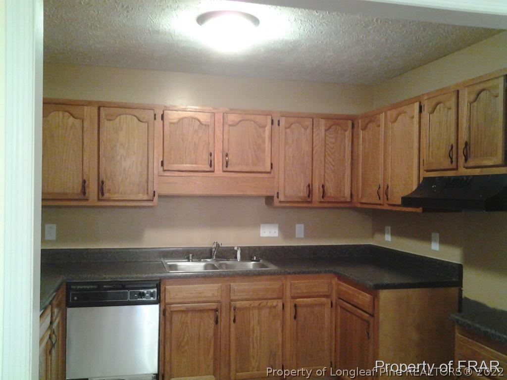 5074 Summer Ridge Road Fayetteville, NC 28303 - Photo 3 of 14 a kitchen with stainless steel appliances granite countertop a sink and cabinets