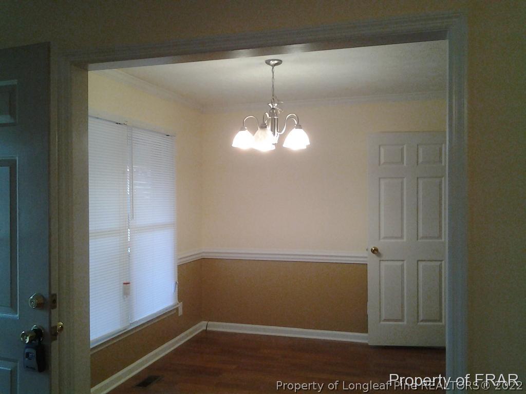 5074 Summer Ridge Road Fayetteville, NC 28303 - Photo 4 of 14 an empty room with wooden floor and windows