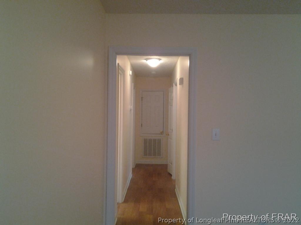 5074 Summer Ridge Road Fayetteville, NC 28303 - Photo 5 of 14 a view of a hallway with wooden floor