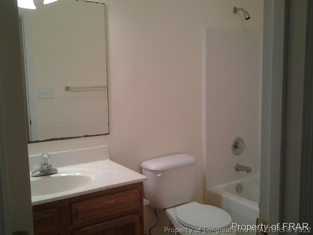 5074 Summer Ridge Road Fayetteville, NC 28303 - Photo 6 of 14 a bathroom with a sink toilet and shower