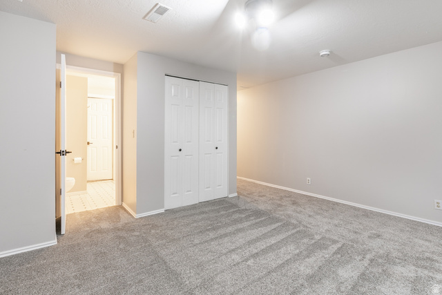11906 Woodridge Road Sandy, UT 84094 - Photo 28 of 35 Neutral-toned room featuring grey wall paint and grey carpeting
