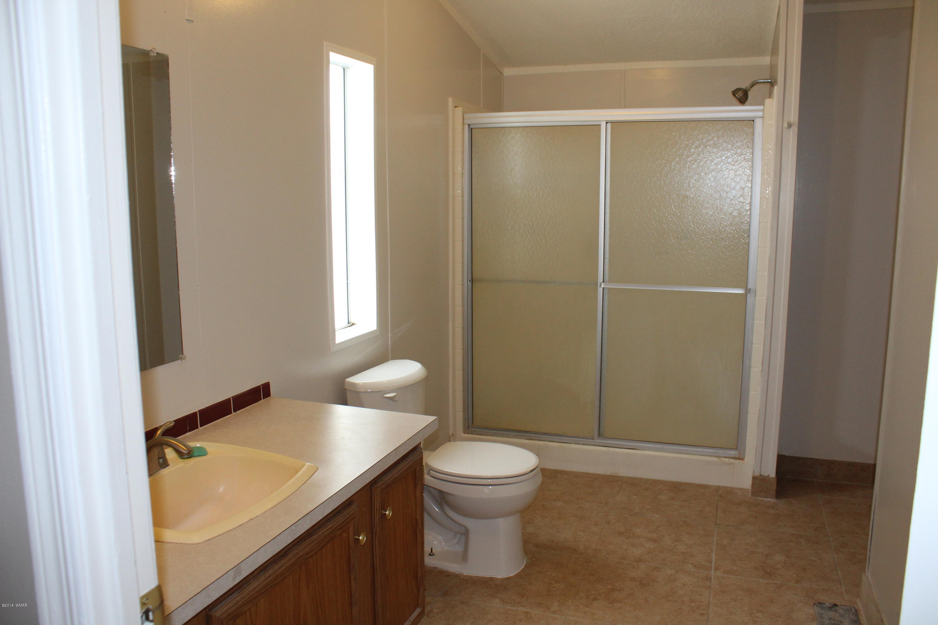 4714 Valley Road Snowflake, AZ 85937 - Photo 17 of 27 a bathroom with a granite countertop sink toilet and shower