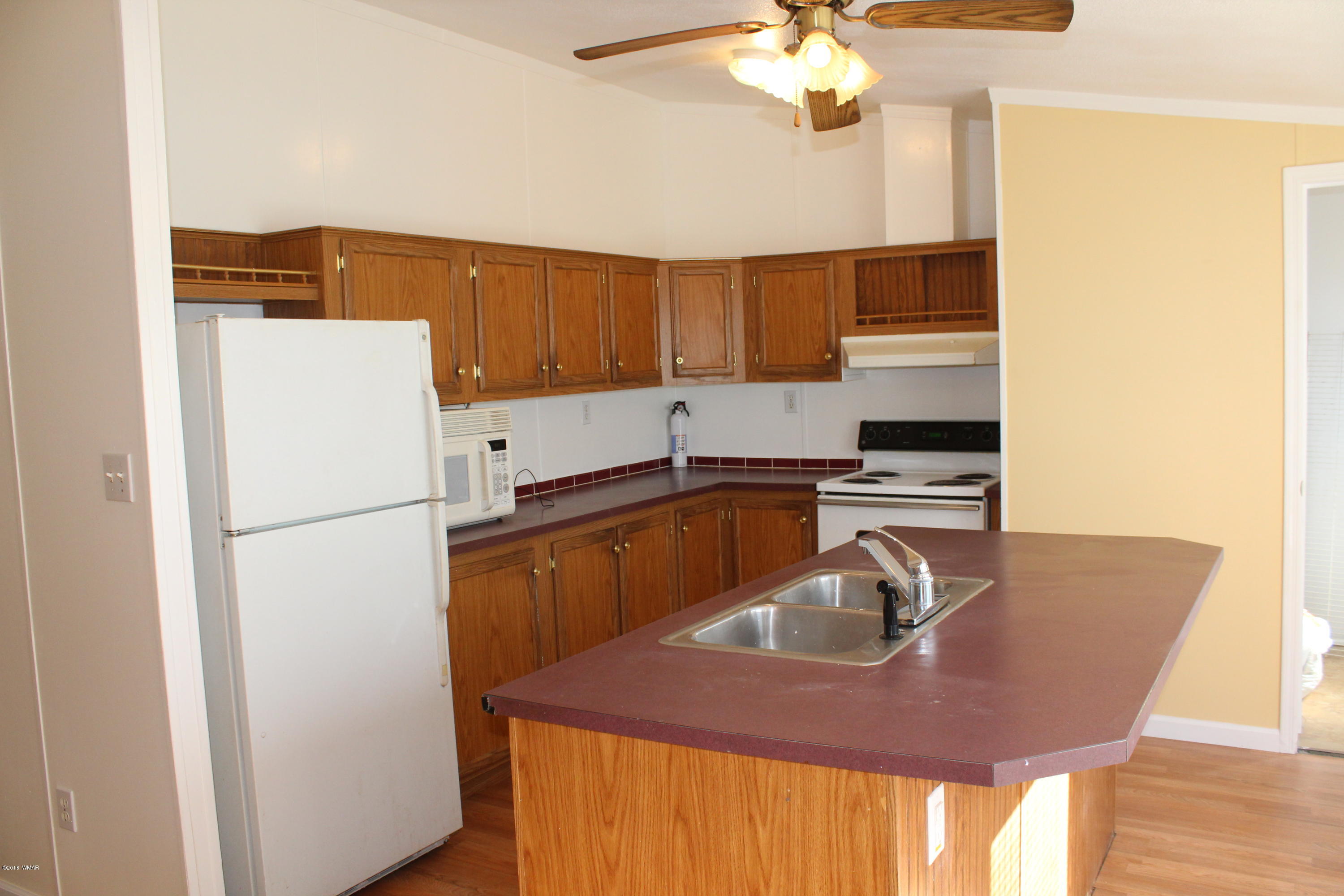 4714 Valley Road Snowflake, AZ 85937 - Photo 10 of 27 a kitchen with a refrigerator a sink and a stove