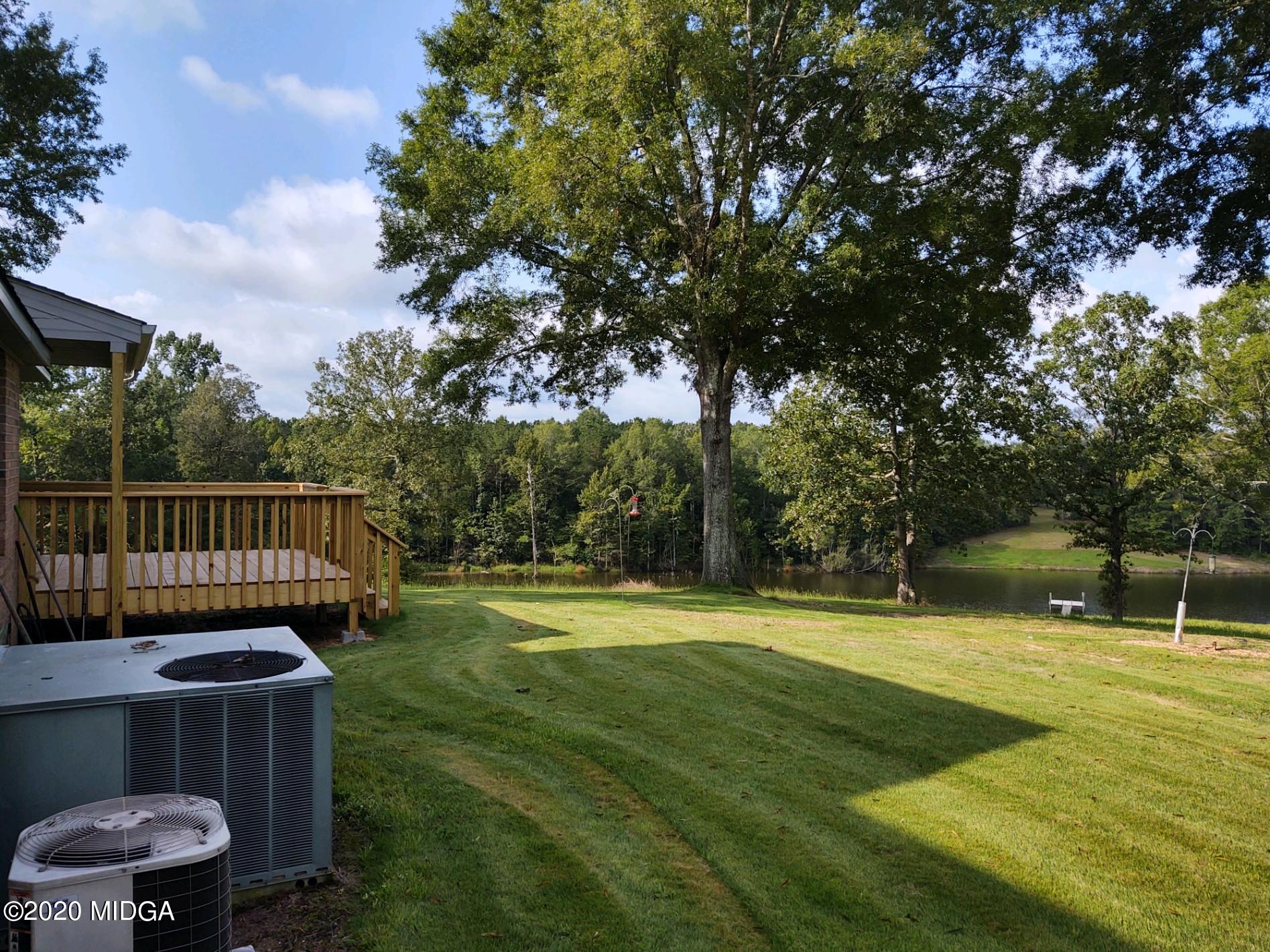 2315 Dennis Road Macon, GA 31220 - Photo 7 of 12 a view of a wooden deck with a big yard