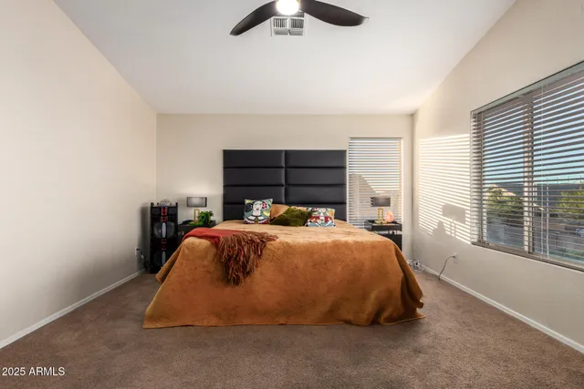 a bed sitting in a bedroom next to a window