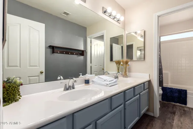 a bathroom with a double vanity sink and a mirror