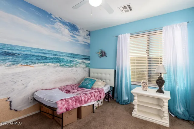 a bedroom with a bed and large windows