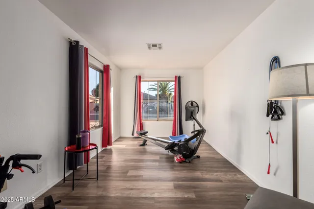 a view of a room with gym equipment and a window