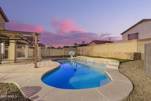 a view of a swimming pool with a lounge chairs
