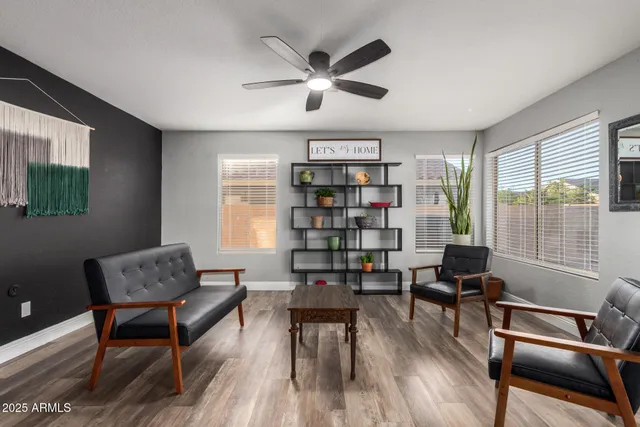a living room with furniture and a book shelf