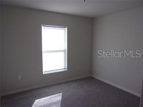 11357 Elgin Boulevard Spring Hill, FL 34608 - Photo 13 of 15 an empty room with a window