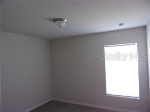 11357 Elgin Boulevard Spring Hill, FL 34608 - Photo 10 of 15 an empty room with a window