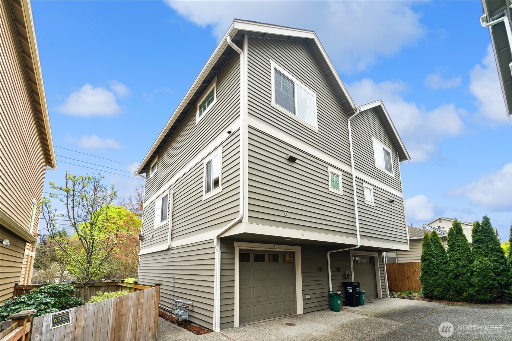 8403 8th Avenue Northwest, Unit B Seattle, WA 98117 - Photo 1 of 16 a front view of a house with a garage