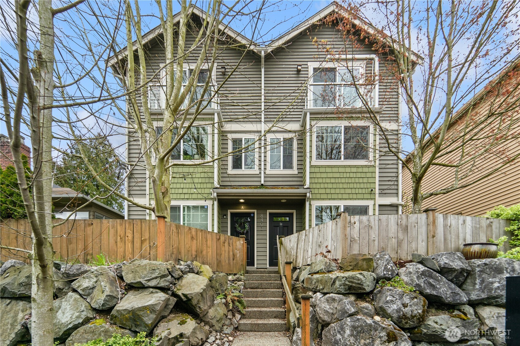 8403 8th Avenue Northwest, Unit B Seattle, WA 98117 - Photo 2 of 16 a front view of a house with a yard