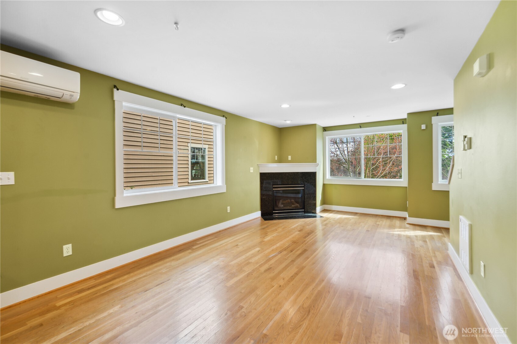 8403 8th Avenue Northwest, Unit B Seattle, WA 98117 - Photo 4 of 16 a view of empty room with wooden floor and fireplace