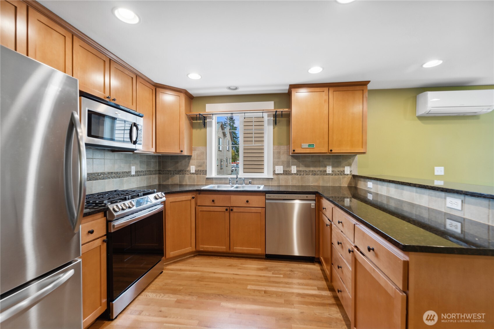8403 8th Avenue Northwest, Unit B Seattle, WA 98117 - Photo 5 of 16 a kitchen with stainless steel appliances granite countertop a stove a sink and a refrigerator