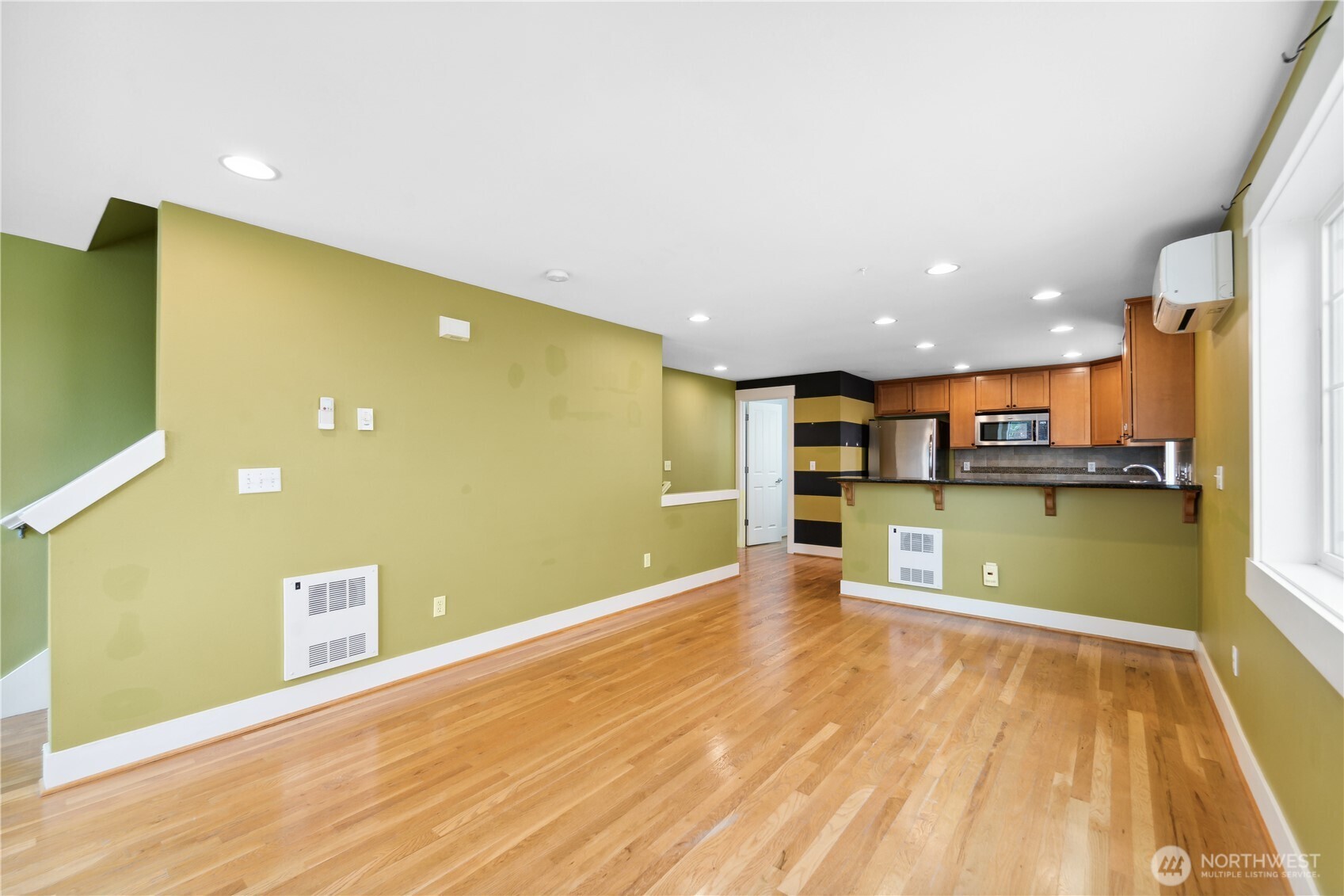 8403 8th Avenue Northwest, Unit B Seattle, WA 98117 - Photo 7 of 16 a view of a kitchen with a kitchen counter top and stainless steel appliances