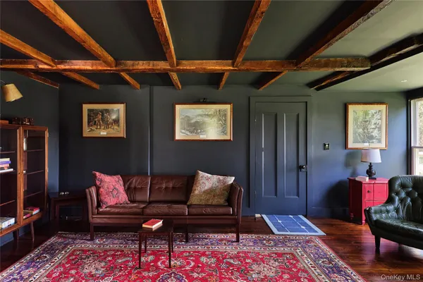 a living room with furniture a rug and a window