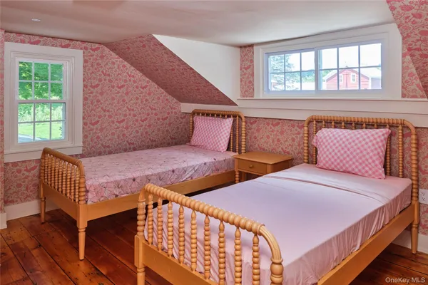 a bedroom with two beds and a window