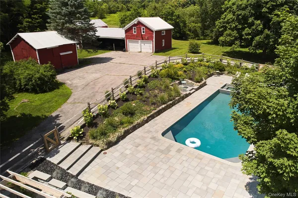 a view of a house with yard swimming pool and a yard