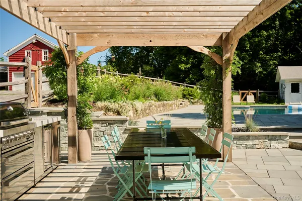 a view of a patio with table and chairs and potted plants
