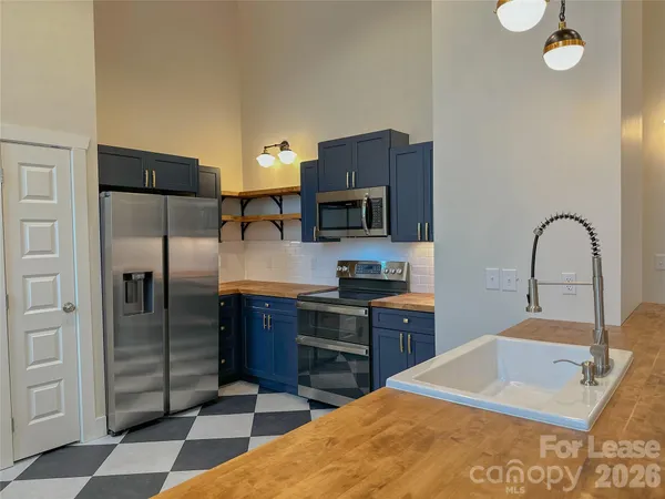 a kitchen with stainless steel appliances and cabinets