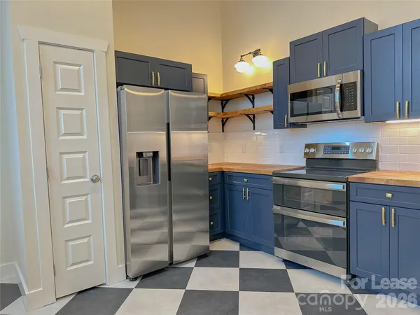 a kitchen with wooden cabinets and a stove top oven
