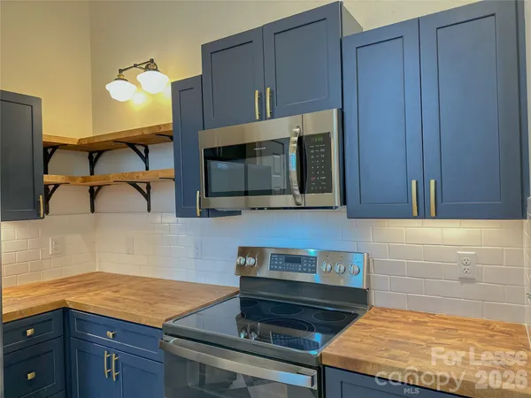 a kitchen with stainless steel appliances a sink and a refrigerator