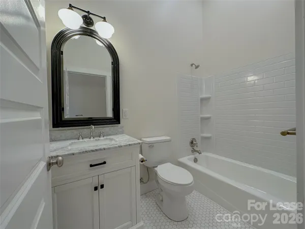 a bathroom with a toilet a sink a vanity and mirror