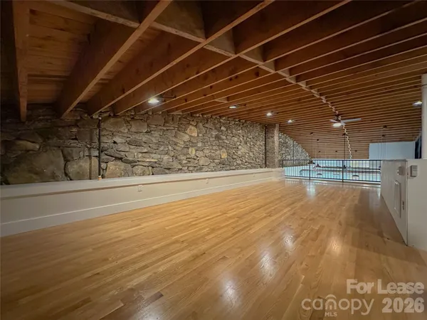 a view of a room with wooden floor
