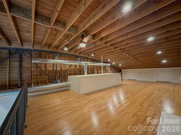 a front view of a house with a garden and plants