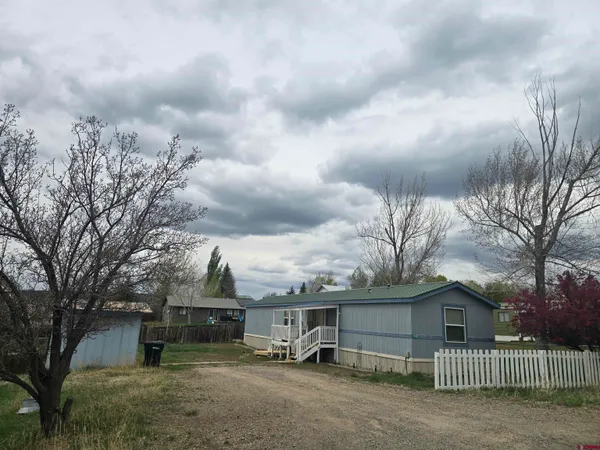 an outdoor view of house with lot of cars