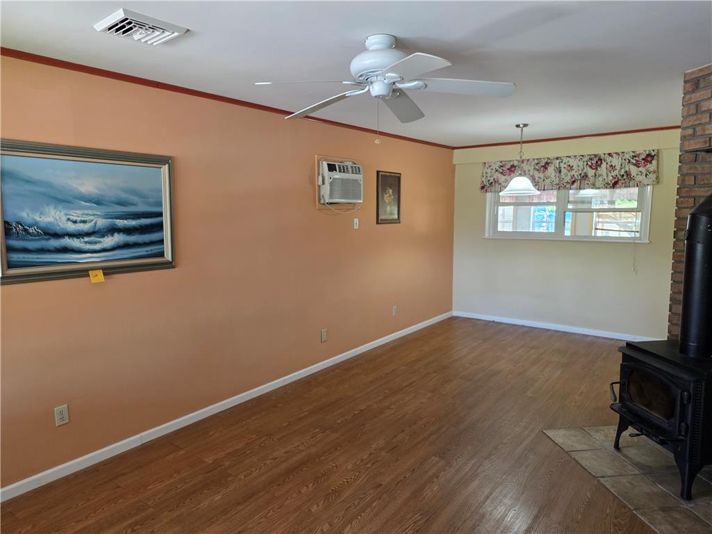 3134 Roxford Road Allentown, PA 18103 - Photo 10 of 34 Warm wood-toned flooring and an inviting fireplace create a comfortable ambiance.