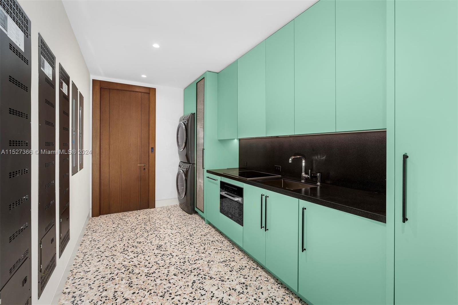 2000 North Bay Road Miami Beach, FL 33140 - Photo 51 of 62 a kitchen with stainless steel appliances granite countertop a refrigerator and a sink