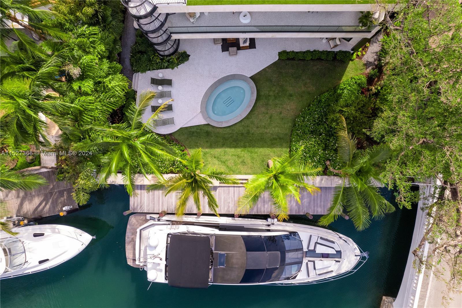 2000 North Bay Road Miami Beach, FL 33140 - Photo 61 of 62 a view of a swimming pool with a dining table and chairs