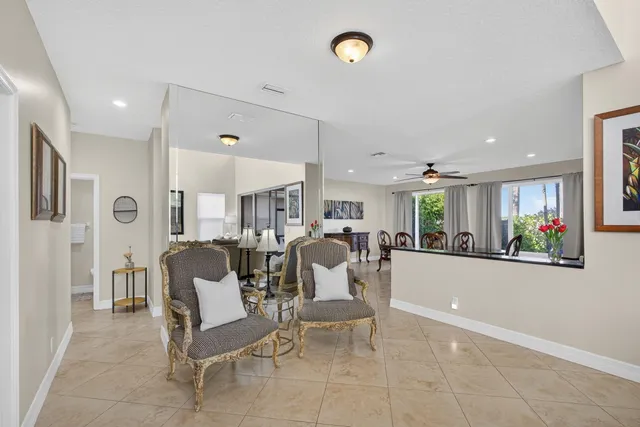 a view of a dining room with furniture and a chandelier