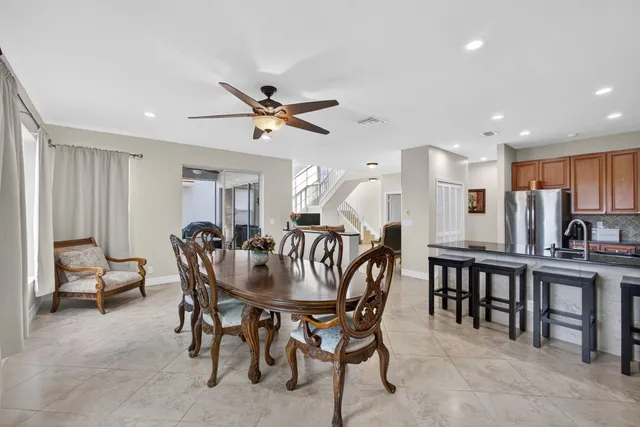 a kitchen with stainless steel appliances granite countertop white cabinets a stove top oven with a sink and dishwasher