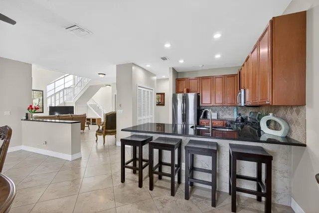 a kitchen with counter top space and living room