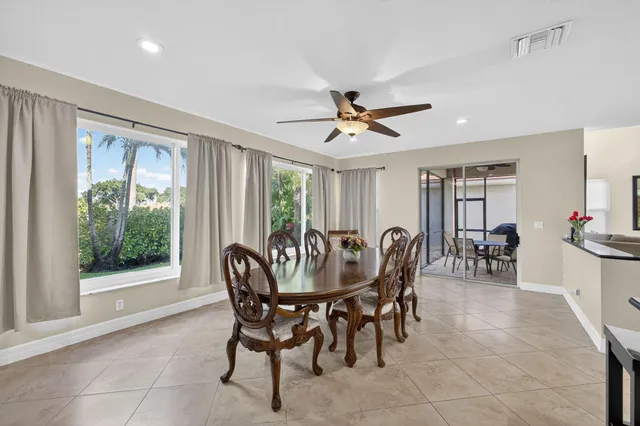a living room with furniture and a dining table