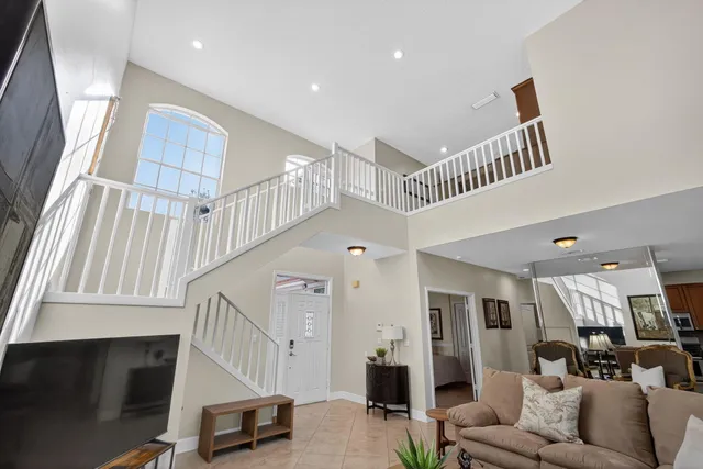 a view of staircase with lots of frames on wall and wooden floor