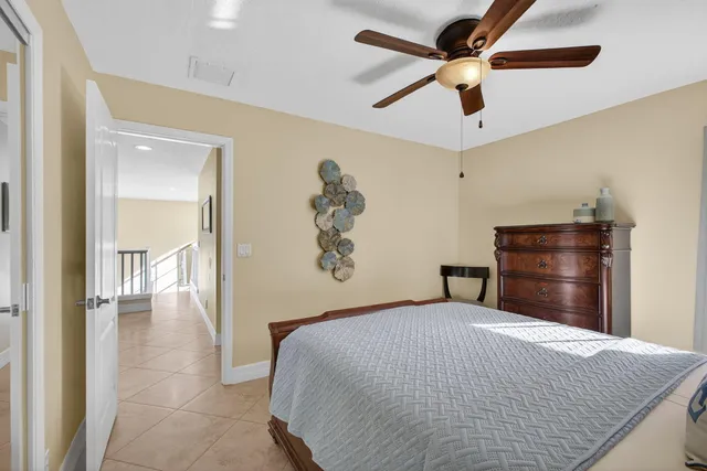 a backyard of a house with table and chairs and potted plants