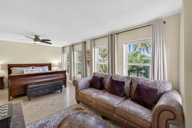 a view of a dining room with furniture a chandelier and kitchen view