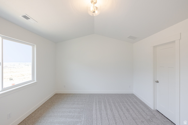 5228 South Acacia Drive, Unit 808 Mapleton, UT 84664 - Photo 16 of 22 Vaulted ceiling bedroom featuring a large window, neutral carpet, white trim, and a contemporary ceiling light fixture