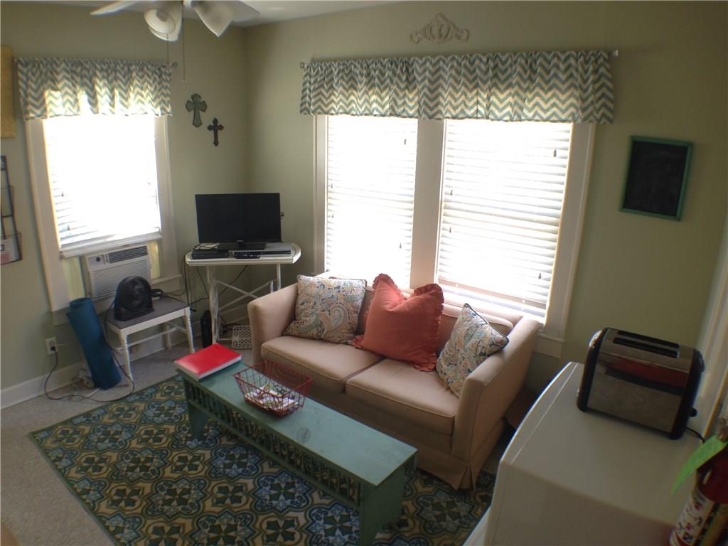 906 West 22nd Street, Unit 4 Austin, TX 78705 - Photo 2 of 6 Living room featuring ceiling fan, cooling unit, and carpet
