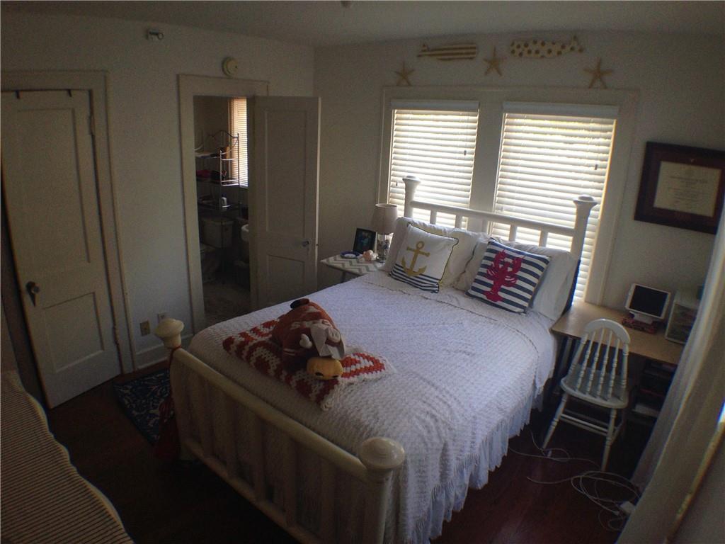 906 West 22nd Street, Unit 4 Austin, TX 78705 - Photo 3 of 6 Bedroom with ensuite bath and dark wood finished floors